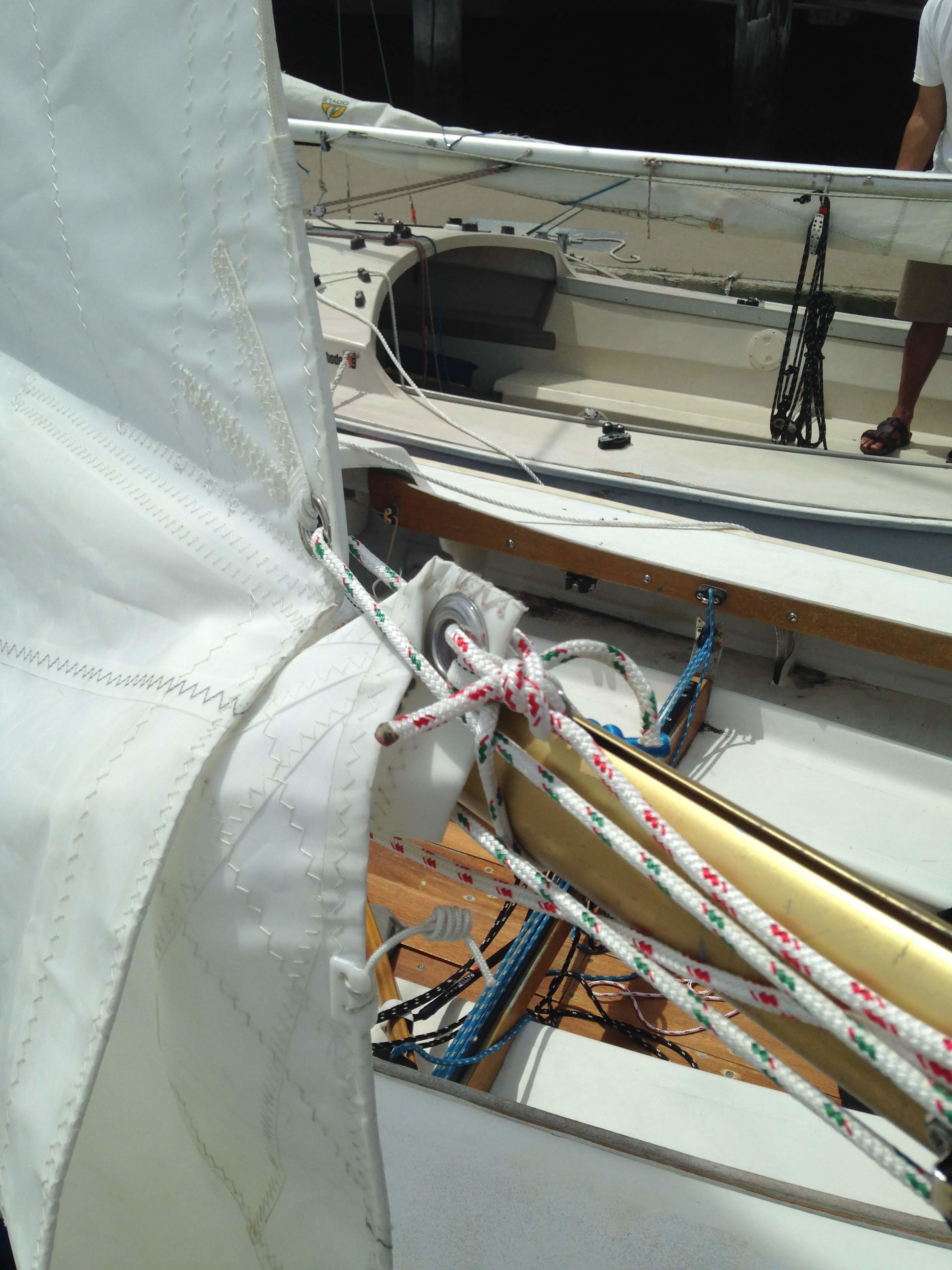 Port side. The new clew, after the reefing line is pulled tight.  The close side pulls abaft.  The far/starboard side (not able to be seen) pulls downward.